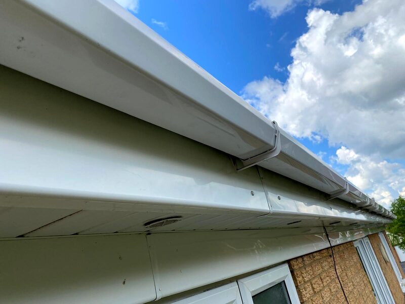 The same gutter run clear and draining after cleaning