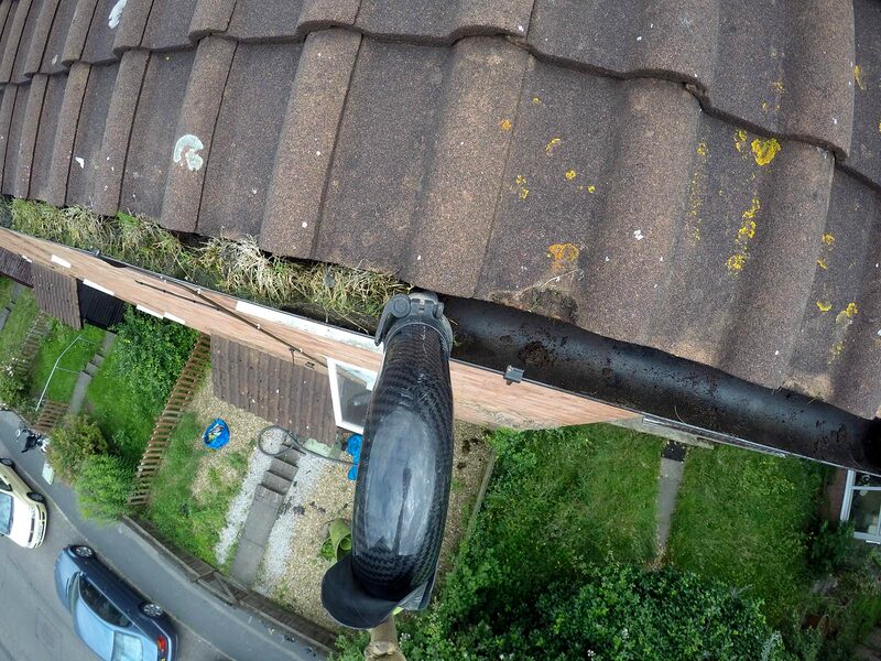 Stained fascia and blocked guttering before washing